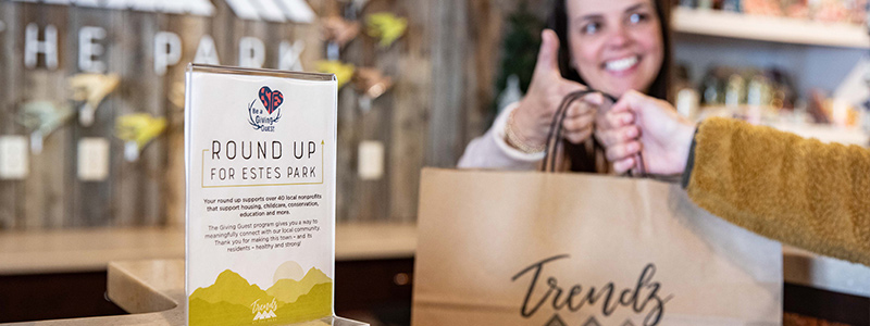 A shopper receiving their purchases at Trendz at the Park